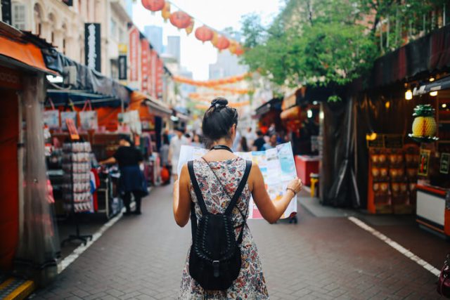 A traveler using google maps to find the nearest spot during her trip to Europe 