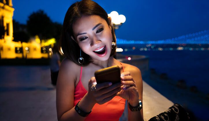 A young girls is excited about the best dating app she found