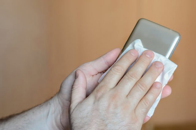 man cleaning mobile phone case
