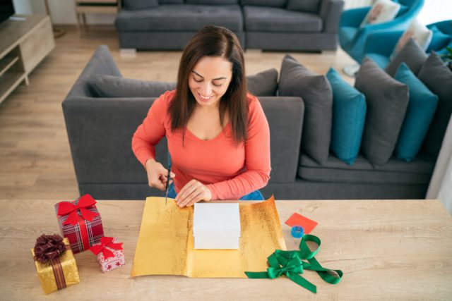 woman putting together a care package to send Long-Distance Christmas gift
