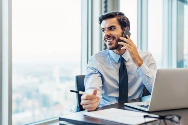 Businessman working and talking on the phone in the office