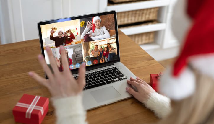 woman at christmas, having video chat with friends and family