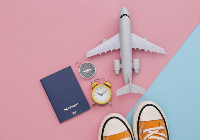travel essentials image showing aero plane shoes passport clock and more 
