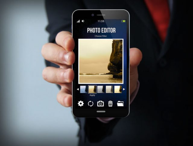 modern photography concept: businessman holding a photo editor smartphone