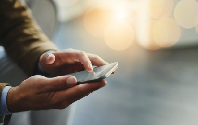 High angle shot of an unrecognizable businessman using a mobile phone having storage issue