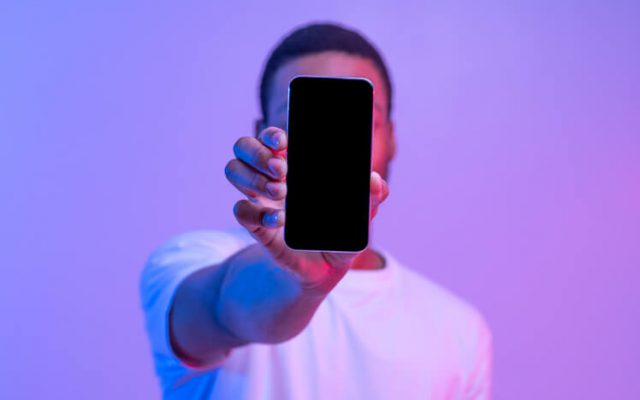 African American Man Holding Smartphone and happy about getting the best phones under $500