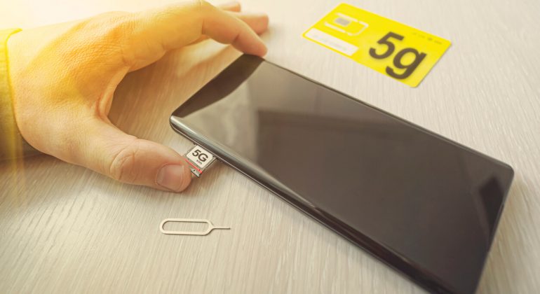 SIM card labeled 5g. Replacing a data only SIM card in a mobile phone with high-speed Internet.
