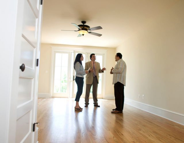 Couple with realtor looking at new home in the UK